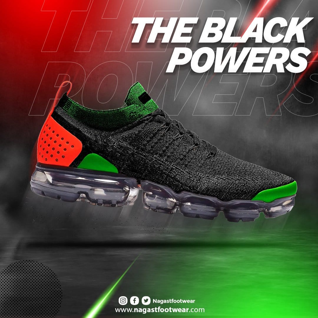 A sneaker with black, green, and red colors, featuring a modern, mesh design and a thick, transparent sole. Side view