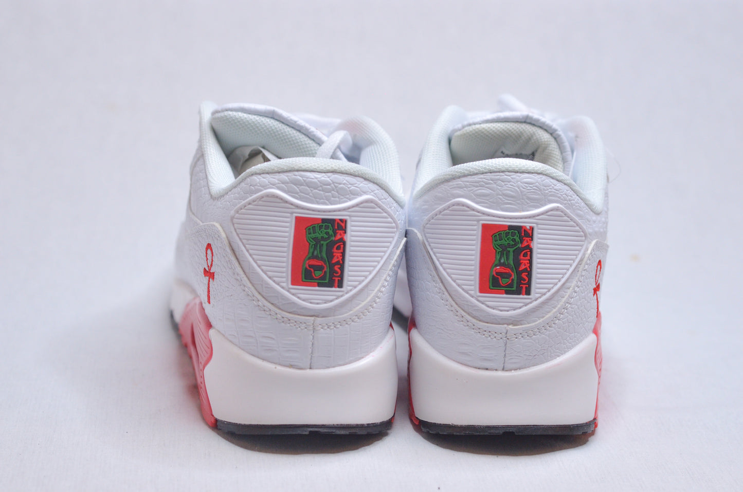 Back view of Marcus Garvey UNIA Star Sneakers showing red heel logo and detailing.