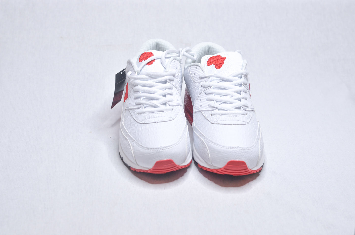 Top view of Marcus Garvey UNIA Star Sneakers, sleek white design with red sole and African continent logo.