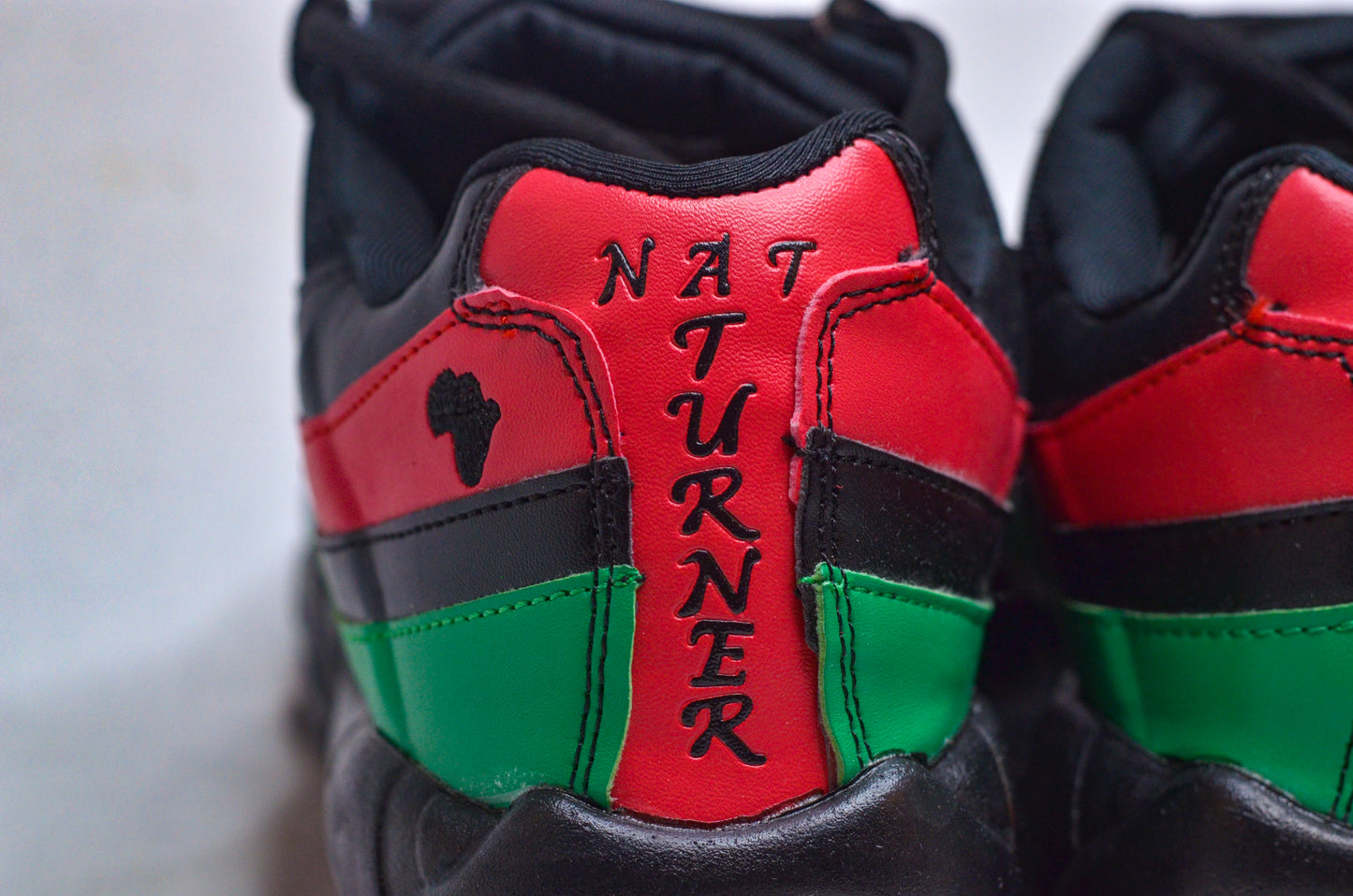 Heel close-up of NAT TURNER MAX Sneakers – African heritage red and green design.