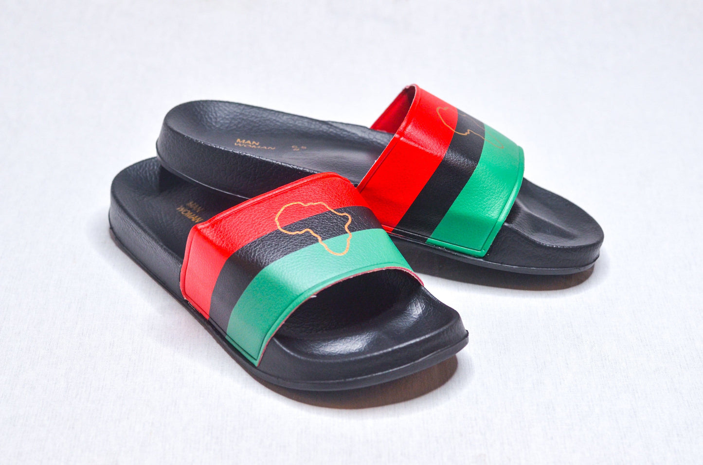 Side angle of RBG Slippers – Black sandals with red, black, and green African heritage design.