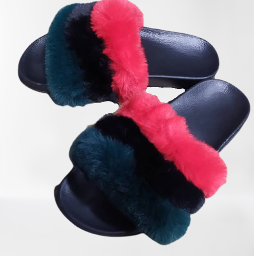 A pair of red, black, and green fur slides with a plush faux fur upper and a flat sole.