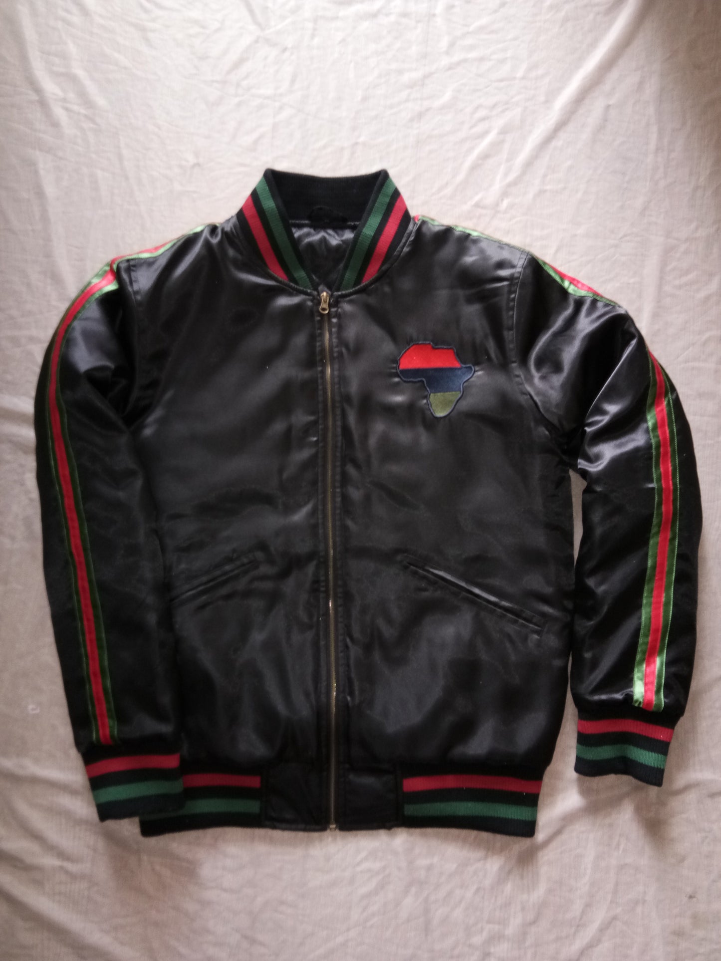 Black satin winter jacket with red, blue, and green accents on the sleeves and chest.