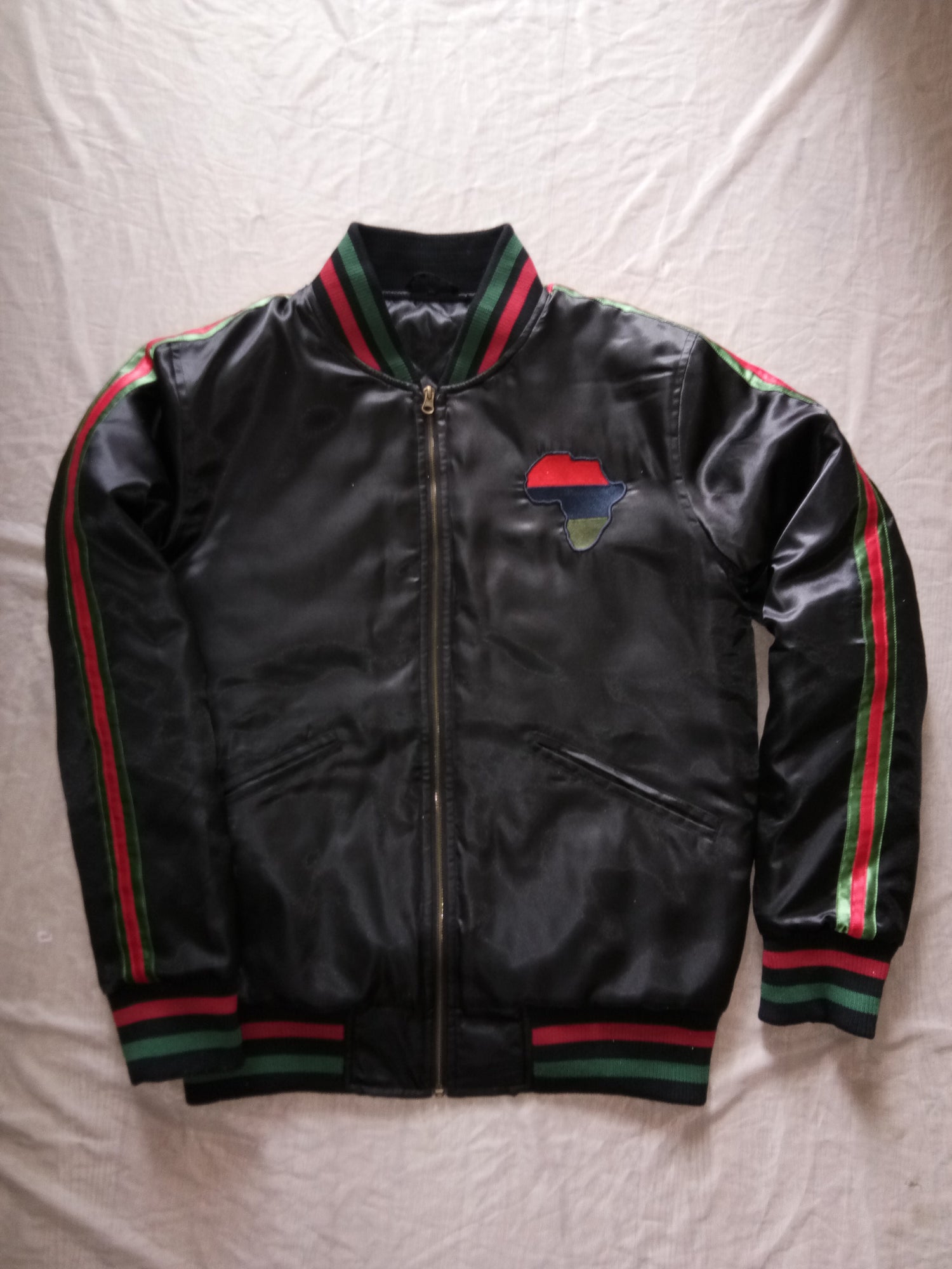 Black satin winter jacket with red, blue, and green accents on the sleeves and chest.