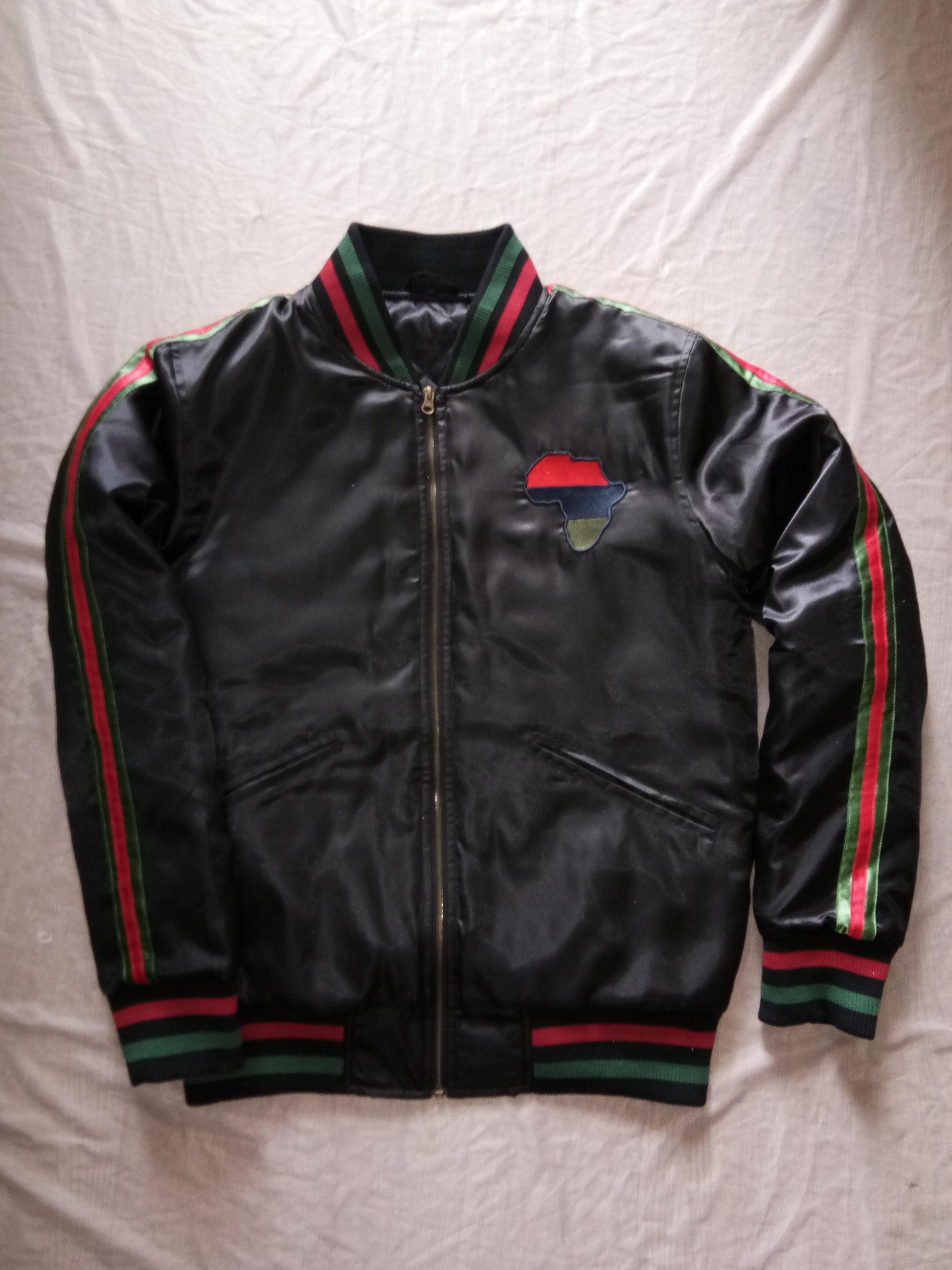 Black satin winter jacket with red, blue, and green accents on the sleeves and chest.