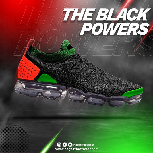 A sneaker with black, green, and red colors, featuring a modern, mesh design and a thick, transparent sole. Side view
