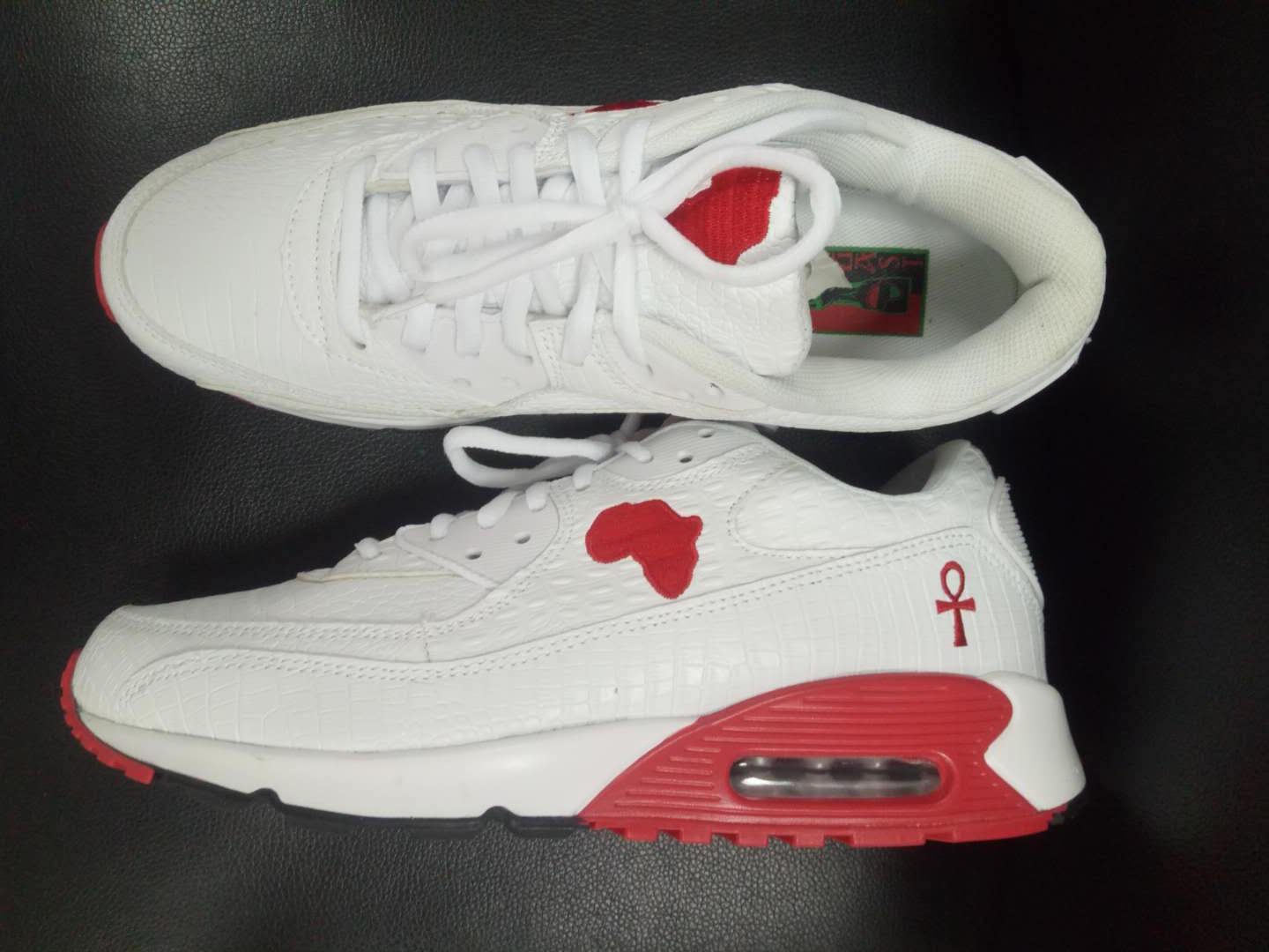 Marcus Garvey UNIA Star Sneakers displayed against black background with red outsole.