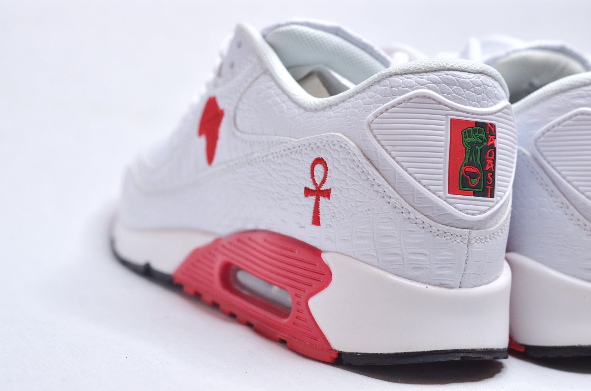  Close-up side view of Marcus Garvey UNIA Star Sneakers highlighting red Africa logo and UNIA star.