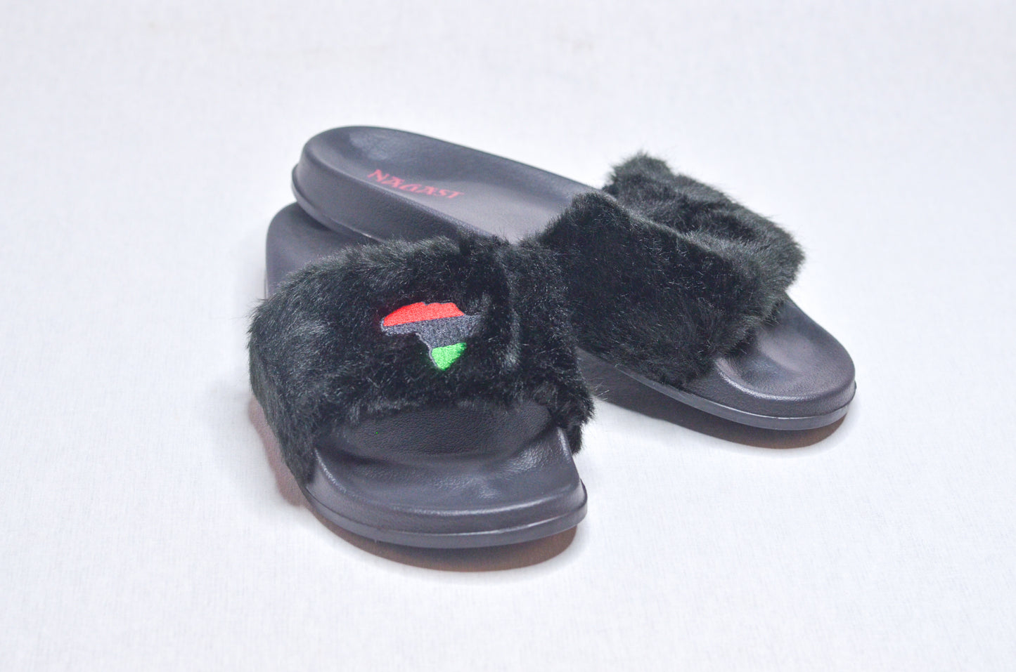 Side view of Queen Nzinga Empress Black Fur Slippers, elegant black design honoring African heritage.