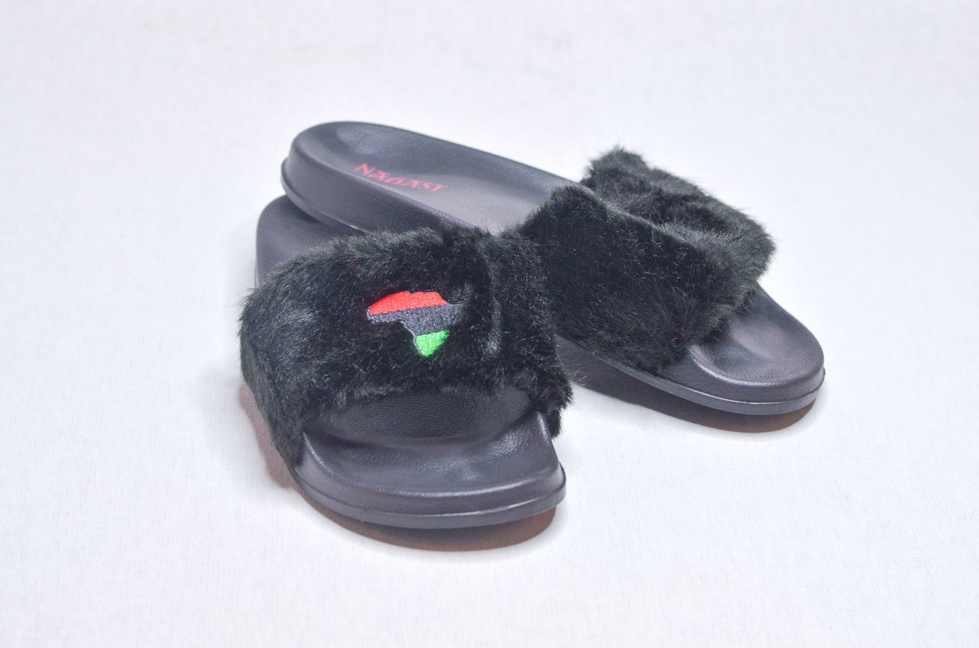 Side view of Queen Nzinga Empress Black Fur Slippers, elegant black design honoring African heritage.