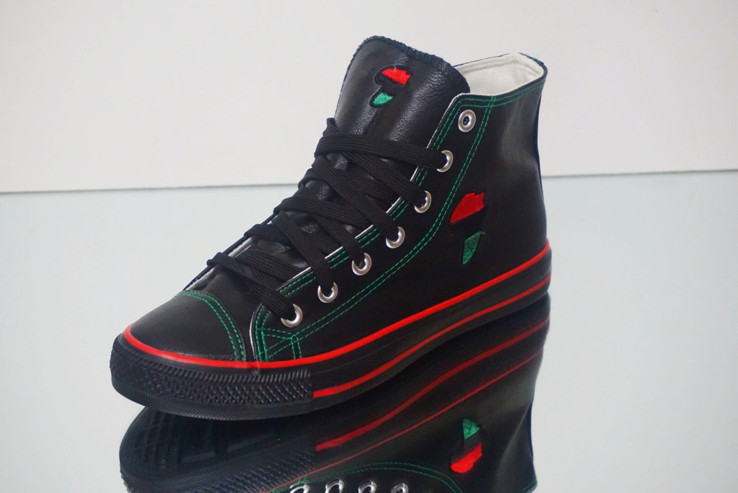 Side view of RBG Hi Top Leather Sneakers, black leather high-top design with red and green heritage stripes.